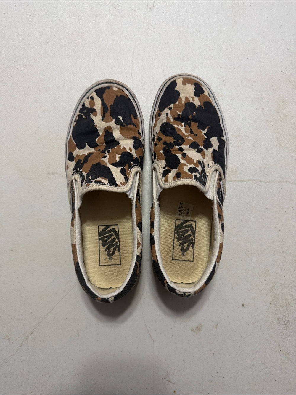 Vans Slip-On Sneakers in Black, Brown, Cream Cow Print
